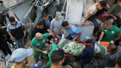 Palestinians Carry Body from Wreckage of Israeli Strike in Gaza